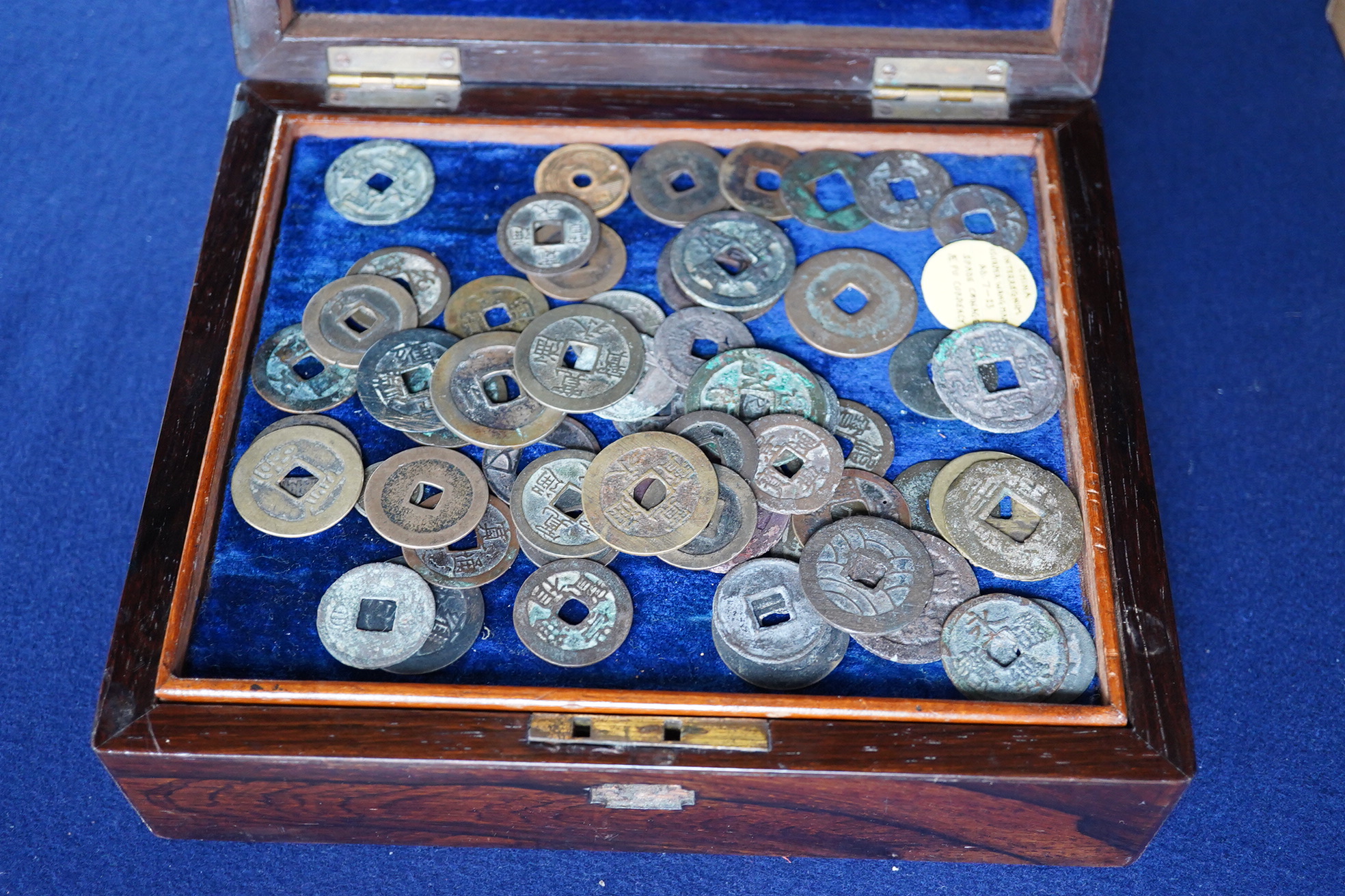 Chinese and Japanese coins, 16th to 20th century, including Chinese cast coins, Ming to Qing dynasty, Japanese Kan’ei Tsuho, in a rosewood box